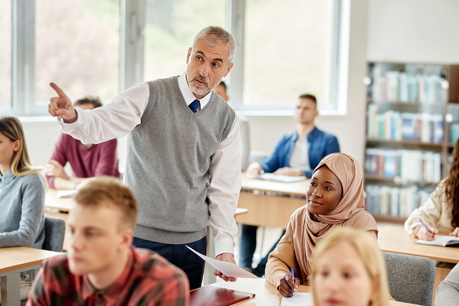 mature-teacher-assisting-black-islamic-student-dur-9ECRV7C.jpg